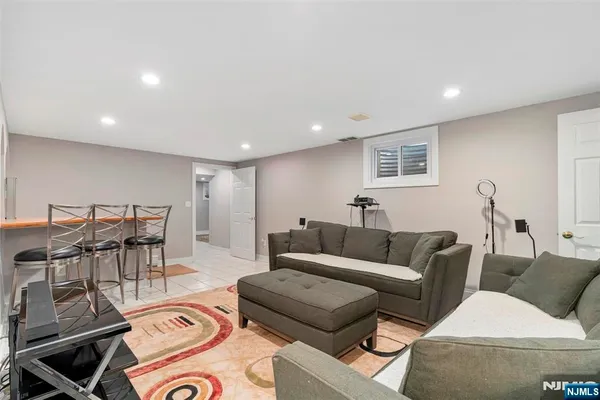 a living room with furniture and a view of kitchen