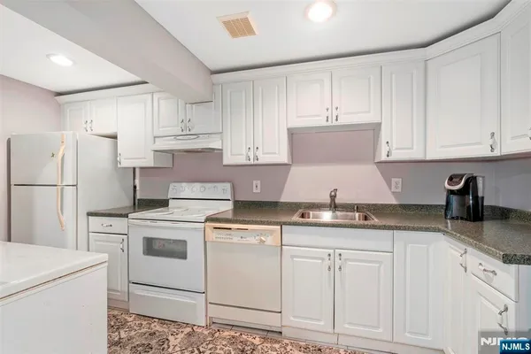 a kitchen that has a sink and a stove in it
