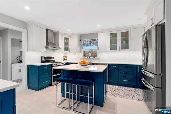 a kitchen with stainless steel appliances granite countertop a refrigerator sink and cabinets