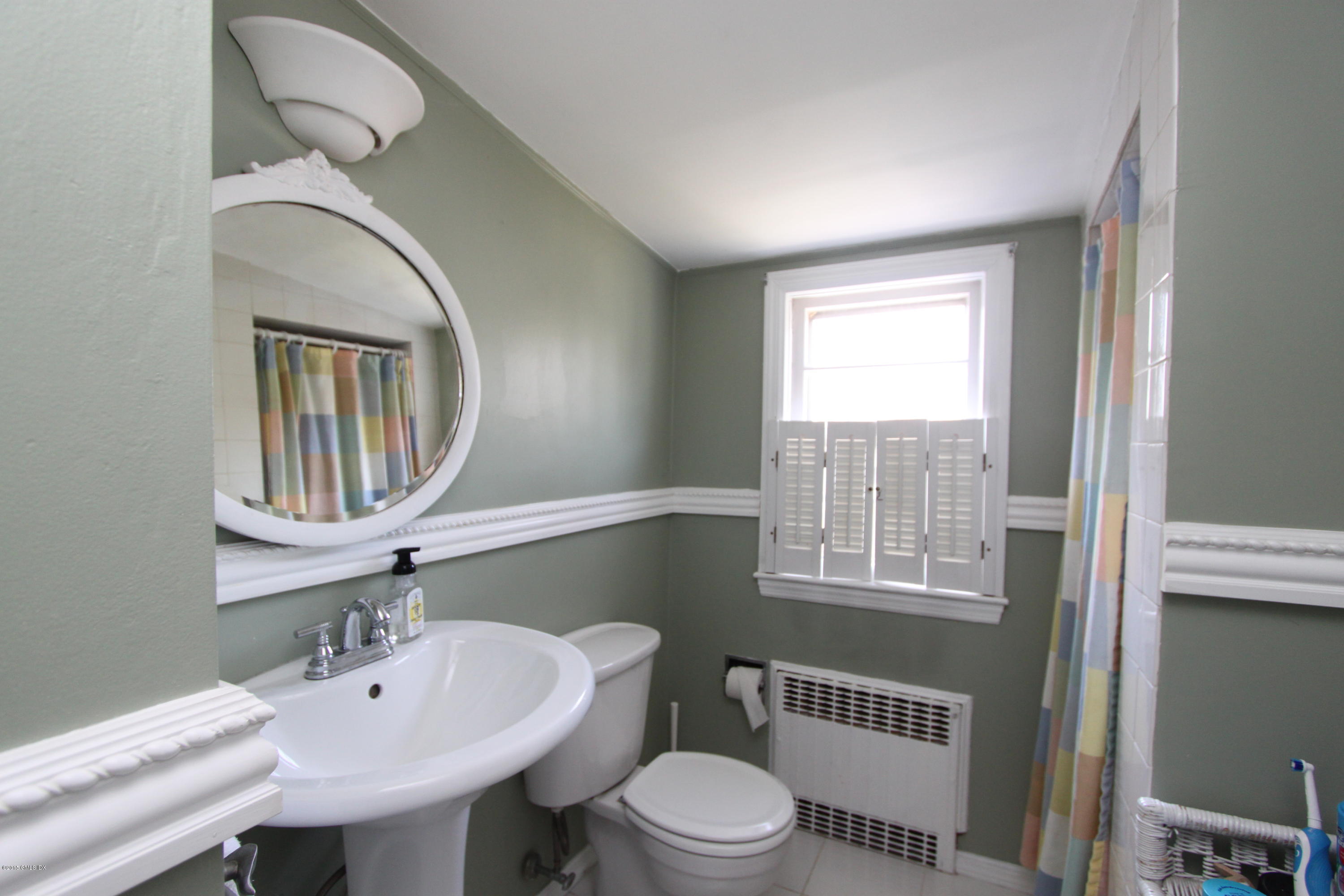 26 Thorn Hill Road Riverside, CT 06878 - Photo 8 of 14 a bathroom with a sink a toilet and a mirror