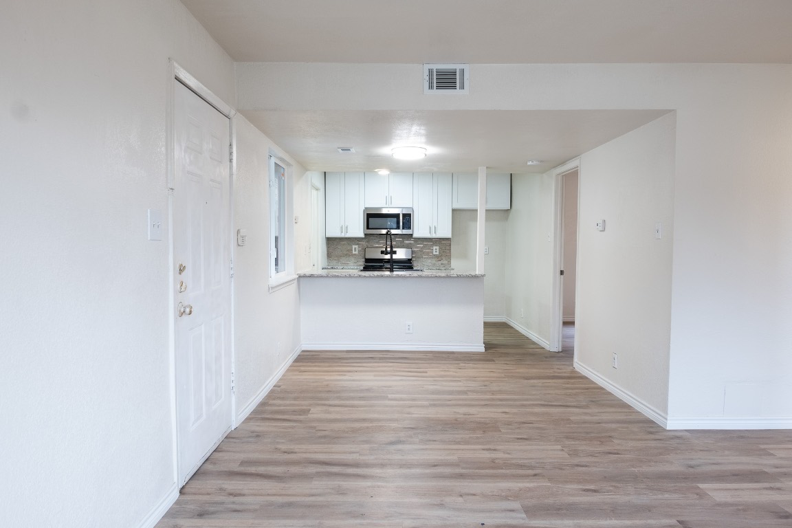 2401 Bucks Run, Unit A Austin, TX 78744 - Photo 11 of 33 a view of a kitchen with wooden floor and electronic appliances
