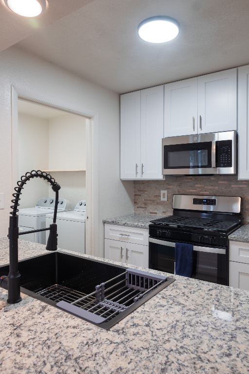 2401 Bucks Run, Unit A Austin, TX 78744 - Photo 13 of 33 a kitchen with kitchen island granite countertop a stove and a sink