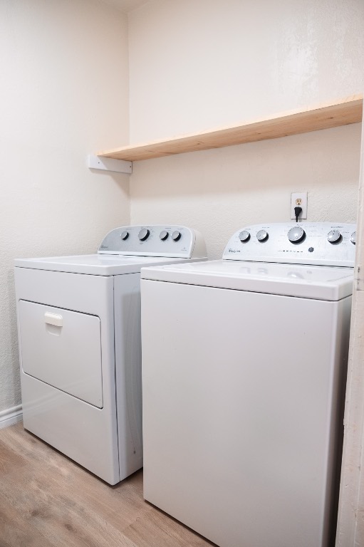 2401 Bucks Run, Unit A Austin, TX 78744 - Photo 14 of 33 Laundry area featuring washer and clothes dryer and light wood finished floors
