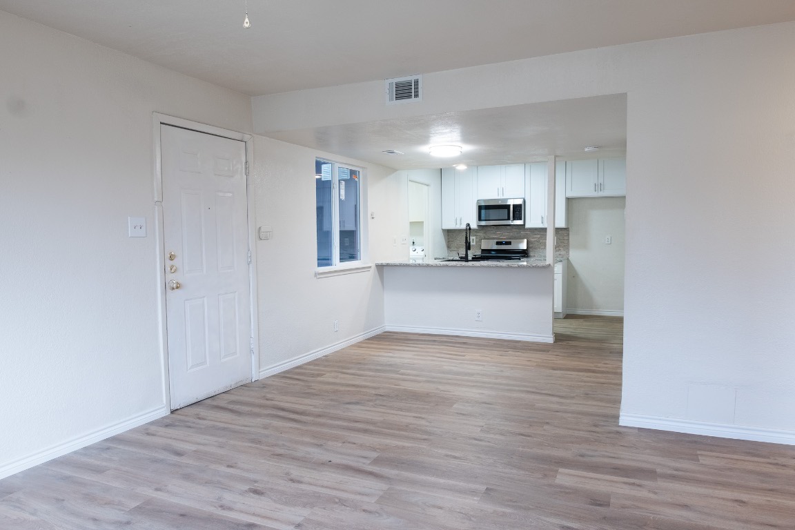 2401 Bucks Run, Unit A Austin, TX 78744 - Photo 16 of 33 a view of a kitchen with a sink and a refrigerator