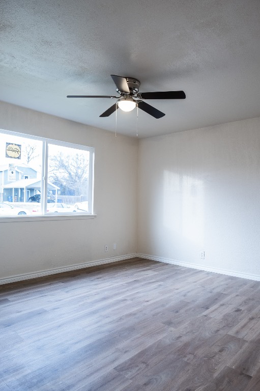 2401 Bucks Run, Unit A Austin, TX 78744 - Photo 19 of 33 a view of an empty room with wooden floor and a window