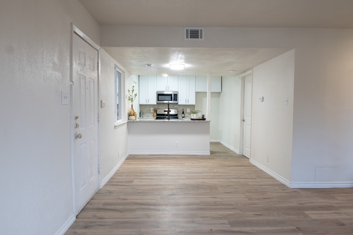 2401 Bucks Run, Unit A Austin, TX 78744 - Photo 2 of 33 a view of a kitchen with wooden floor and electronic appliances