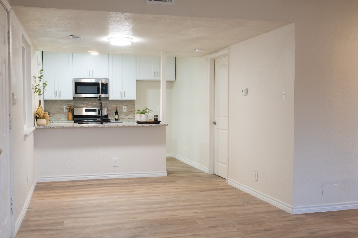 2401 Bucks Run, Unit A Austin, TX 78744 - Photo 23 of 33 a view of kitchen with granite countertop cabinets and refrigerator