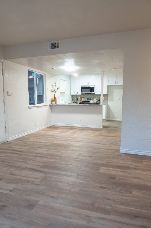 2401 Bucks Run, Unit A Austin, TX 78744 - Photo 24 of 33 Unfurnished living room with light wood-style floors