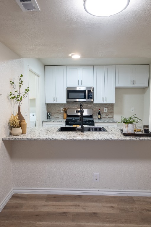 2401 Bucks Run, Unit A Austin, TX 78744 - Photo 25 of 33 a kitchen with a sink a stove and cabinets