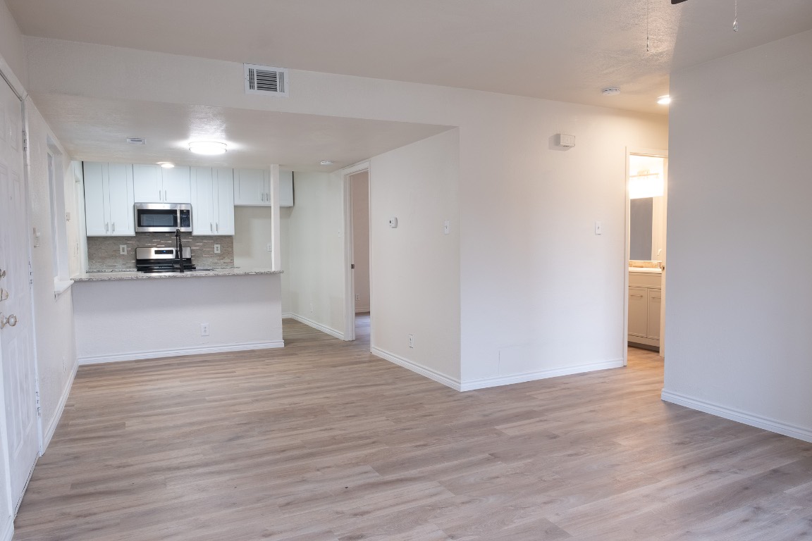 2401 Bucks Run, Unit A Austin, TX 78744 - Photo 26 of 33 a view of a kitchen with a sink and dishwasher a refrigerator with wooden floor
