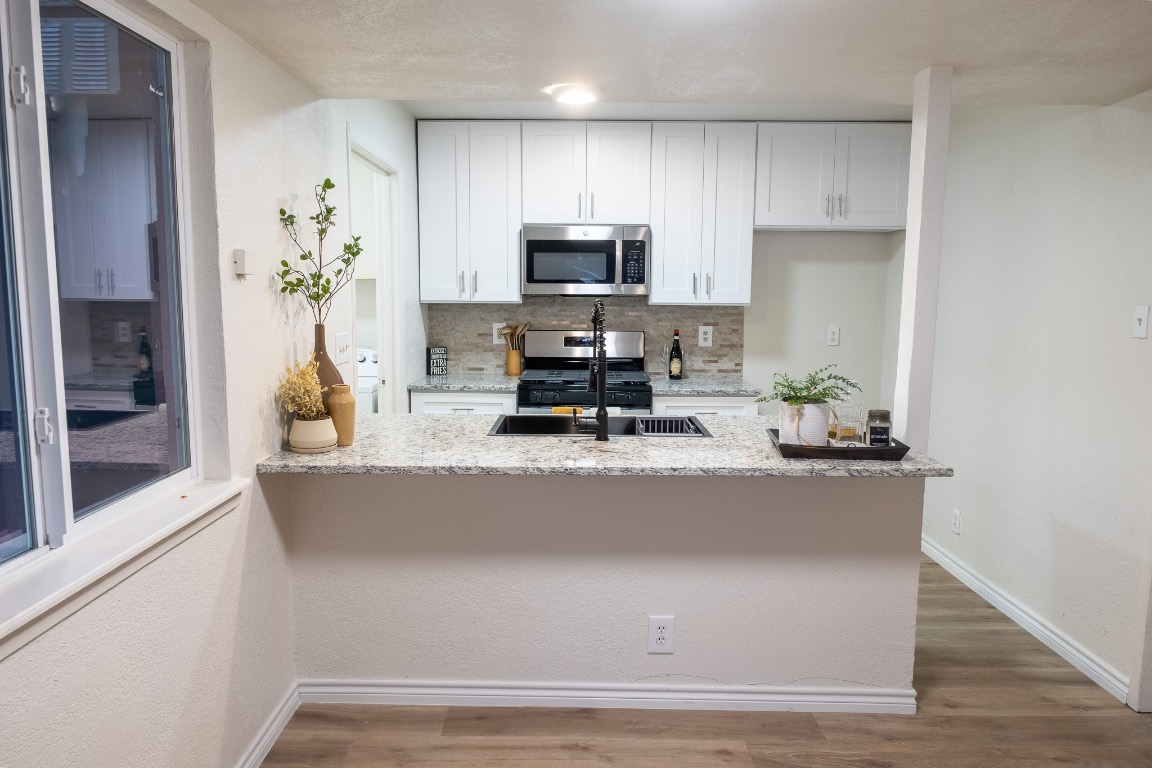 2401 Bucks Run, Unit A Austin, TX 78744 - Photo 29 of 33 a kitchen with kitchen island a counter top space appliances and cabinets