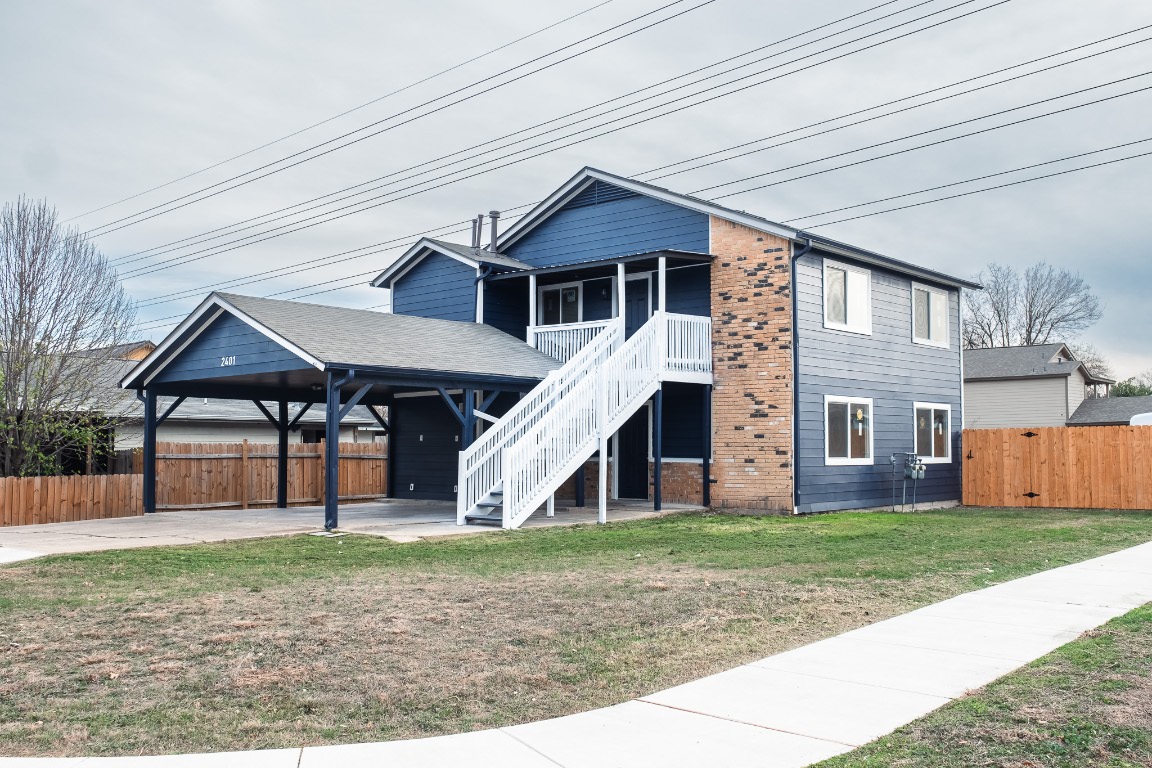2401 Bucks Run, Unit A Austin, TX 78744 - Photo 8 of 33 a front view of a house with a yard
