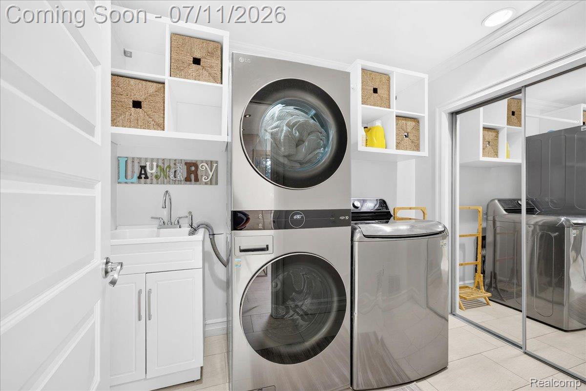 23750 East River Road Grosse Ile, MI 48138 - Photo 27 of 54 Dedicated laundry area featuring a utility sink with a white vanity cabinet and integrated shelving