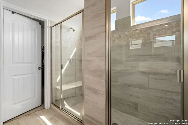 a bathroom with a glass shower door