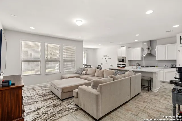 a living room with furniture and kitchen view