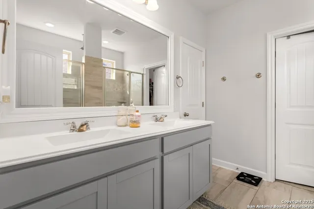 a bathroom with a double vanity sink mirror and double