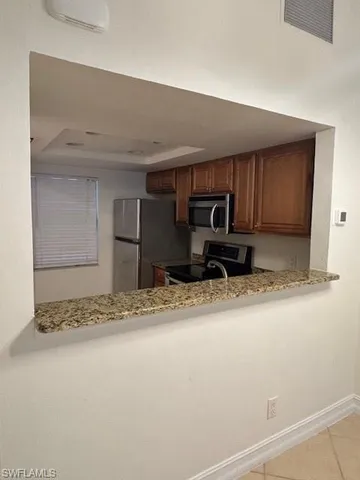 a view of kitchen with cabinets
