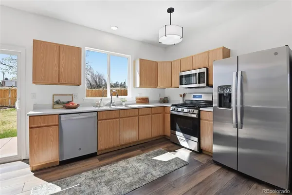a kitchen with a refrigerator and a stove