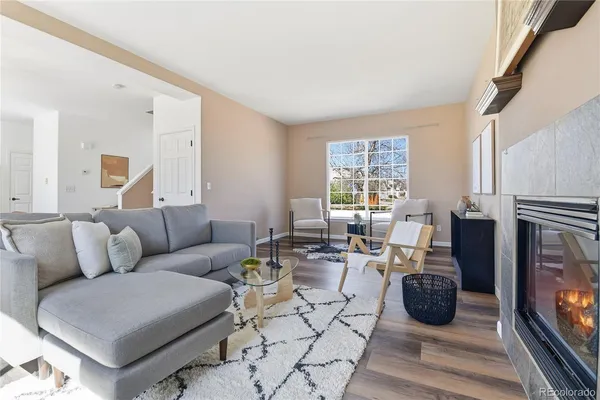 a living room with fireplace furniture and a flat screen tv
