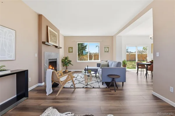 a living room with furniture dining area and a fireplace