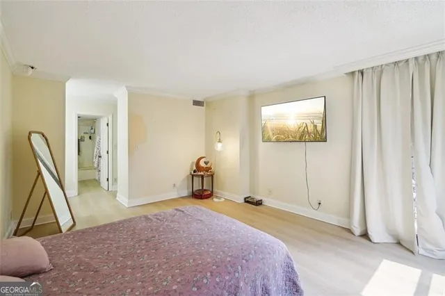 a spacious bedroom with a bed and a couch