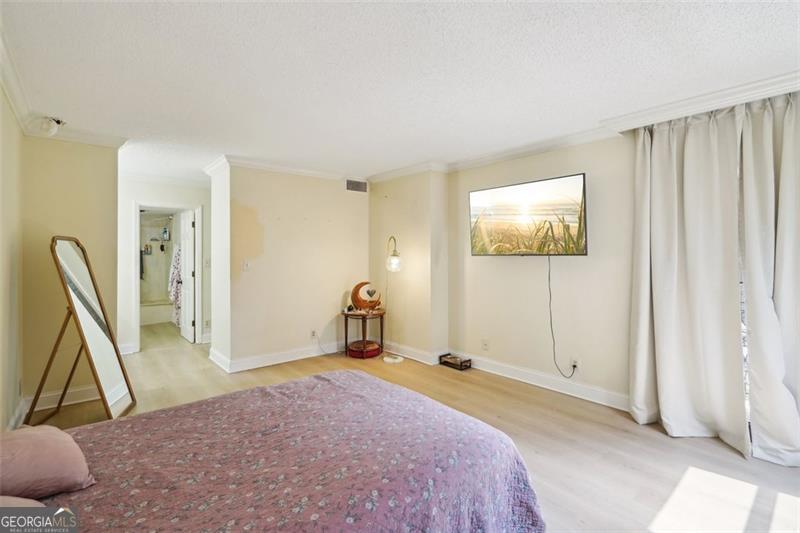 3530 Piedmont Road Northeast, Unit 2I Atlanta, GA 30305 - Photo 13 of 26 a spacious bedroom with a bed and a couch