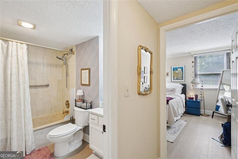 3530 Piedmont Road Northeast, Unit 2I Atlanta, GA 30305 - Photo 17 of 26 a bathroom with a sink toilet and shower