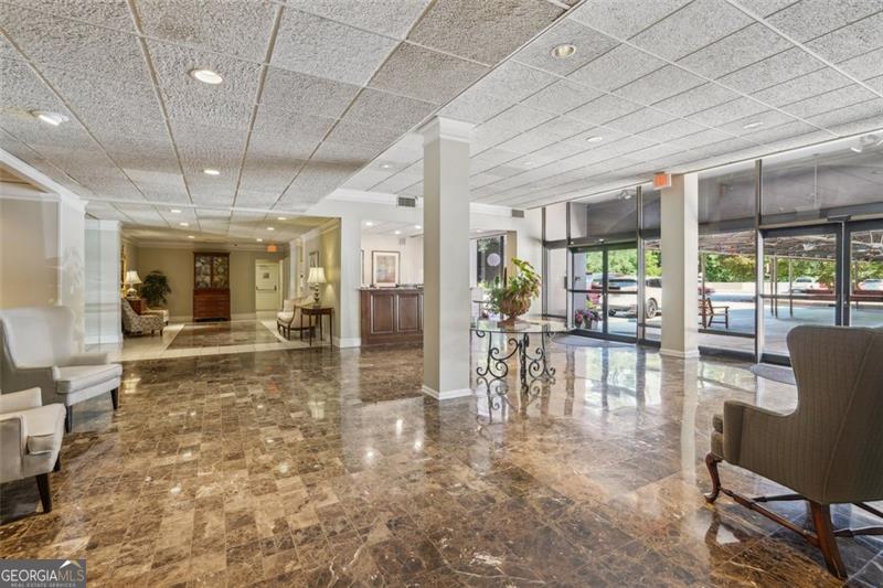 3530 Piedmont Road Northeast, Unit 2I Atlanta, GA 30305 - Photo 19 of 26 a dining room with furniture a chandelier and fireplace