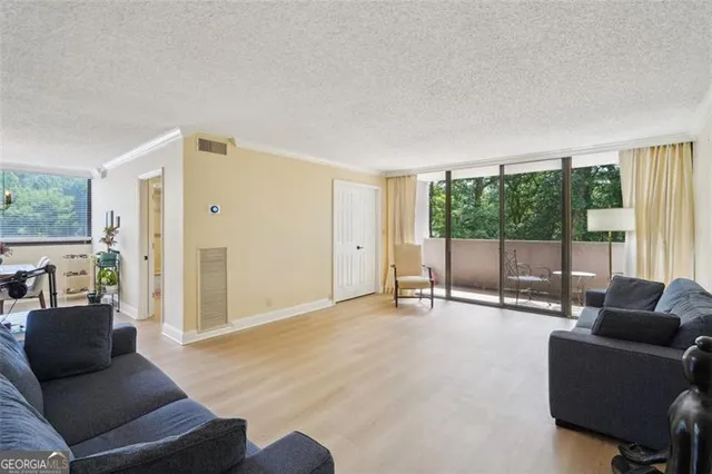 a living room with furniture and large windows