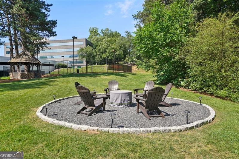 3530 Piedmont Road Northeast, Unit 2I Atlanta, GA 30305 - Photo 25 of 26 a view of a swimming pool with a sitting space