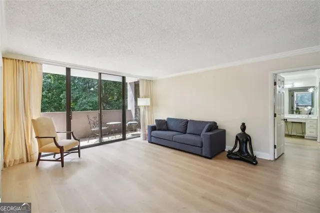 a living room with furniture and a floor to ceiling window