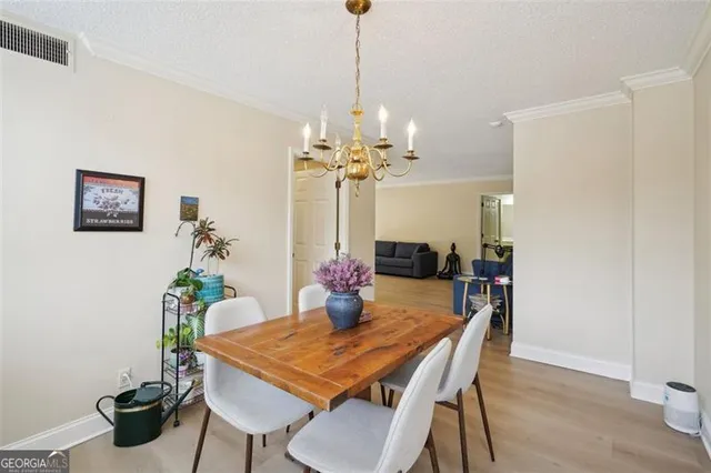 a dining room with furniture and chandelier