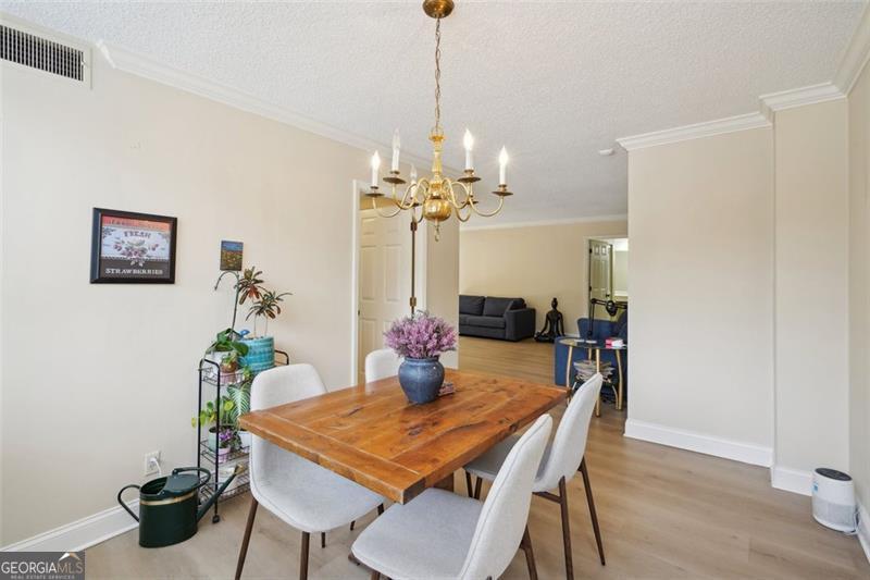 3530 Piedmont Road Northeast, Unit 2I Atlanta, GA 30305 - Photo 5 of 26 a dining room with furniture and chandelier