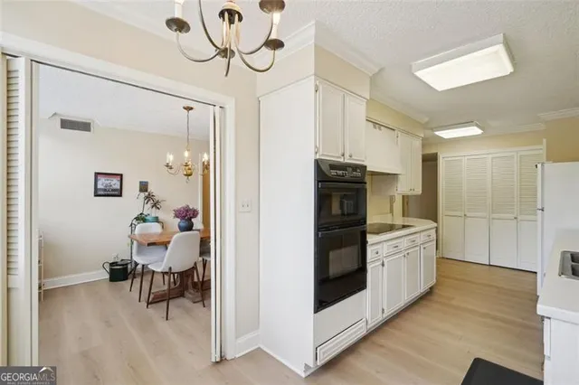 a kitchen with stainless steel appliances kitchen island granite countertop a refrigerator and a sink