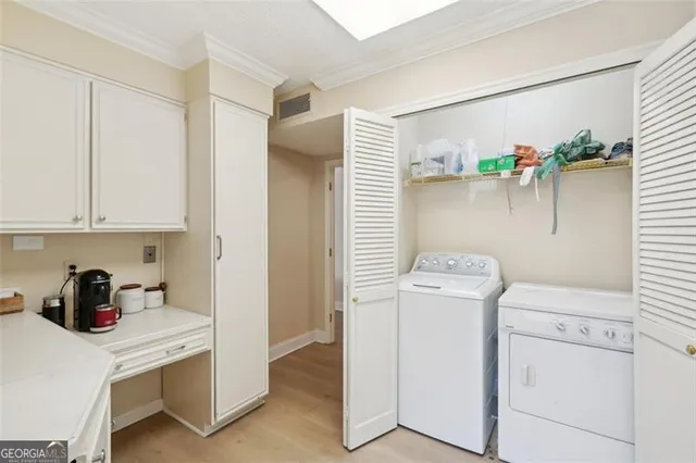 a view of storage and utility room with washer and dryer