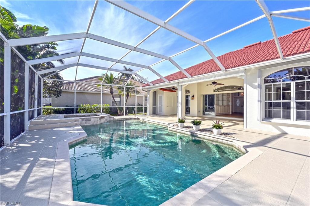 2312 Harrier Run Naples, FL 34105 - Photo 14 of 21 a swimming pool with outdoor seating and yard