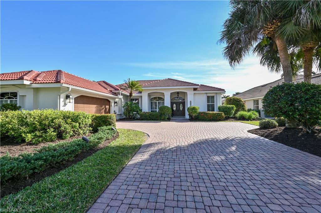2312 Harrier Run Naples, FL 34105 - Photo 3 of 21 a front view of a house with a yard and potted plants