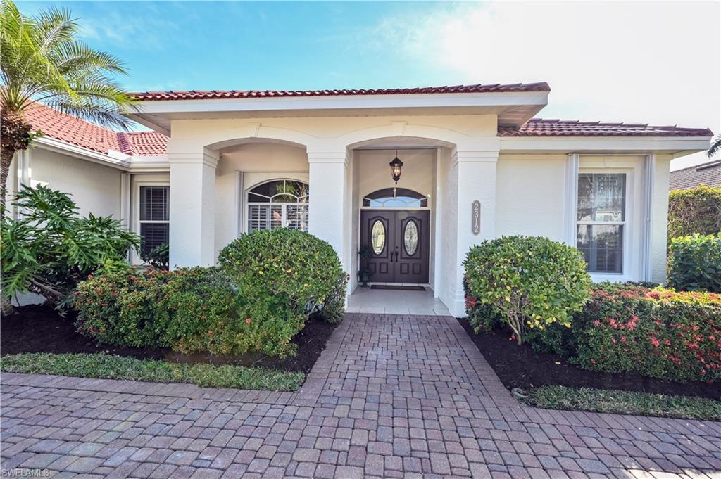 2312 Harrier Run Naples, FL 34105 - Photo 4 of 21 a front view of a house with garden