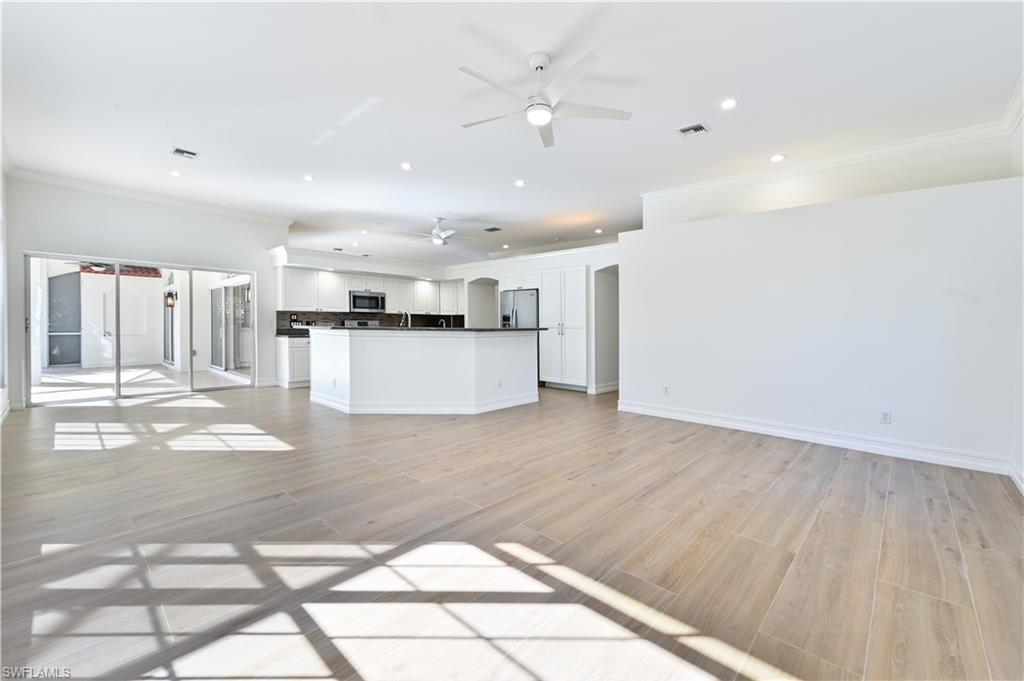 2312 Harrier Run Naples, FL 34105 - Photo 9 of 21 a view of large living room with wooden floor