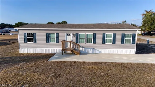 a front view of a house with yard and porch