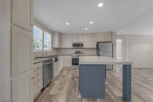 a kitchen with refrigerator cabinets and wooden floor