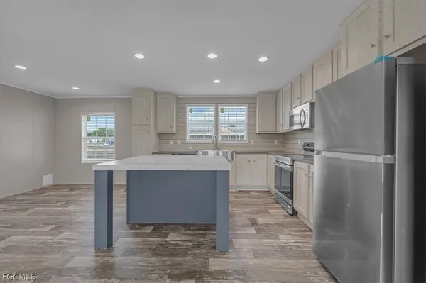 a kitchen with a sink stove and cabinets