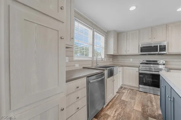 a kitchen with a sink a stove a microwave and refrigerator