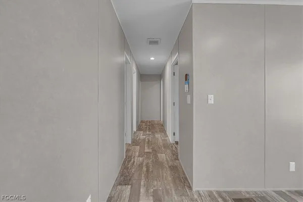 a view of a room with wooden floor