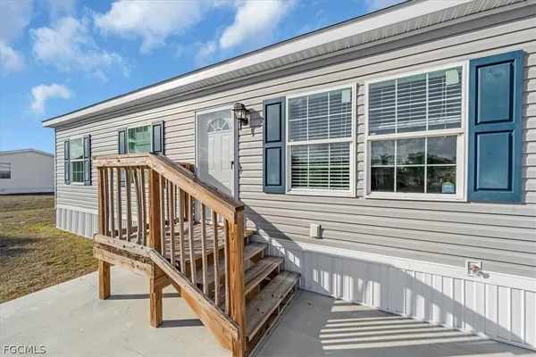 a view of a house with wooden deck