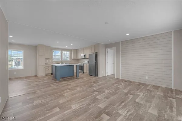 a view of a kitchen with a sink and a refrigerator