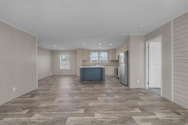 a view of kitchen and empty room
