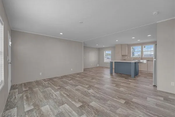 a view of a kitchen with wooden floor and electronic appliances