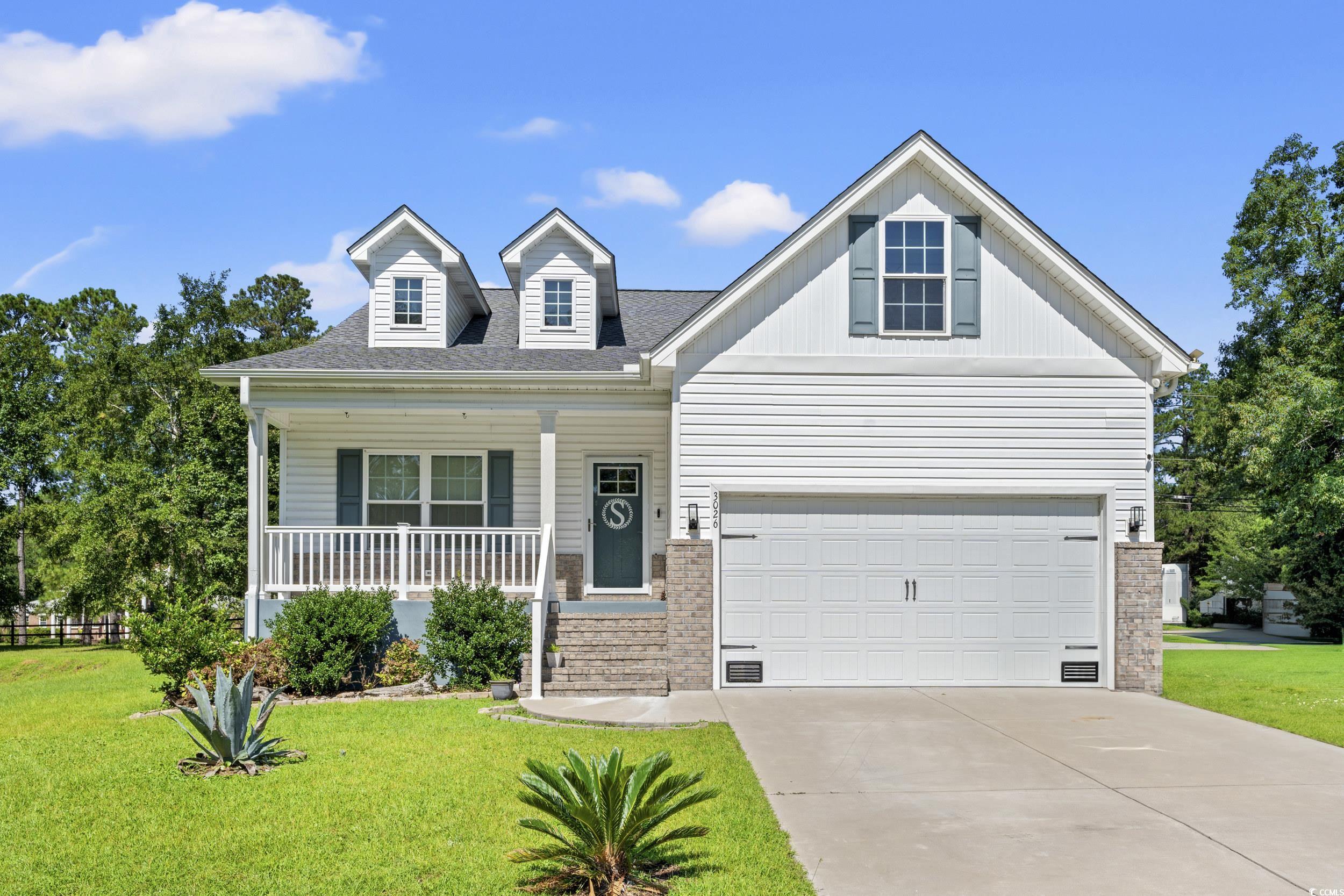 3026 Millstone Place Georgetown, SC 29440 - Photo 1 of 34 View of front of property with covered porch, a front lawn, driveway, roof with shingles, and brick siding