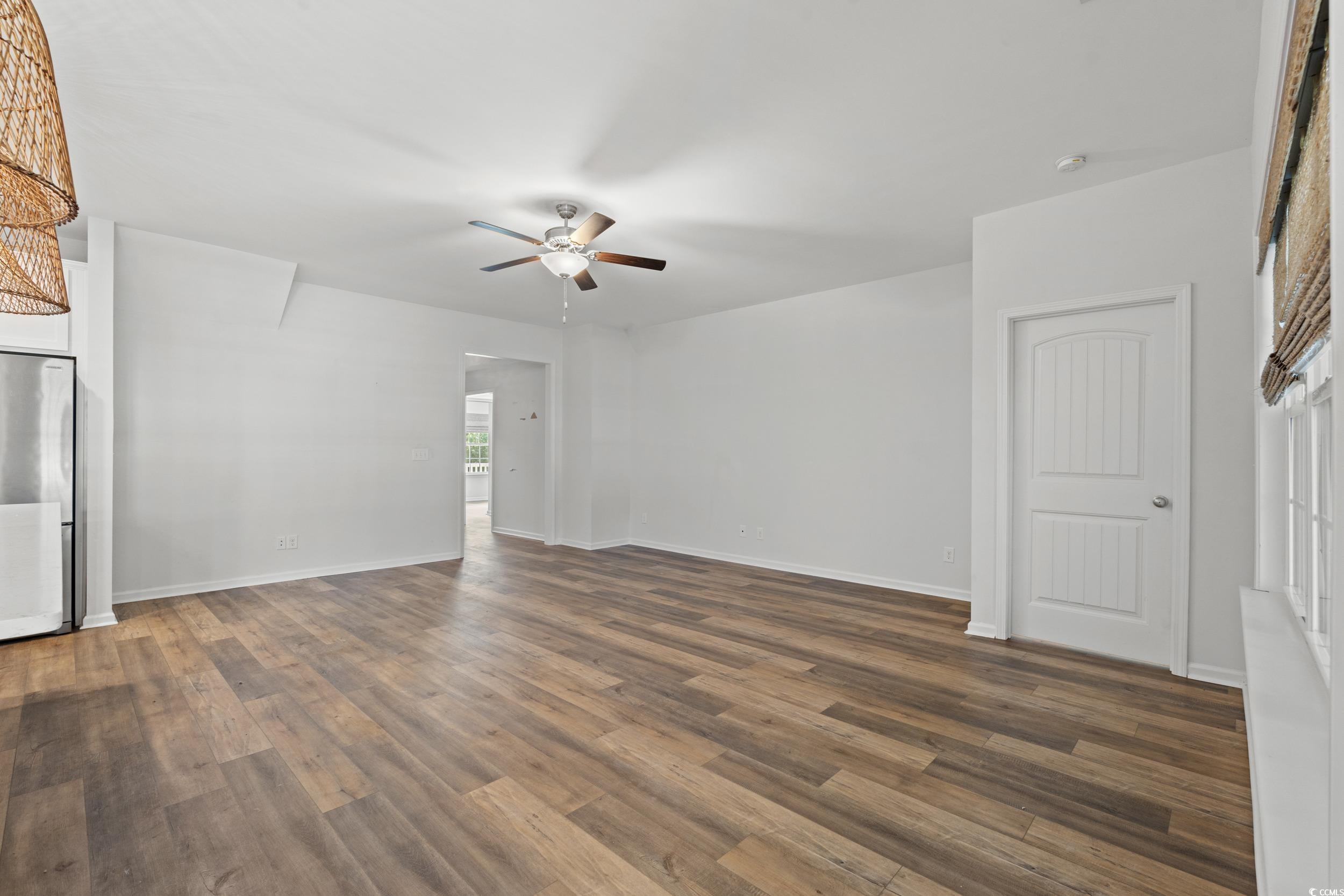 3026 Millstone Place Georgetown, SC 29440 - Photo 16 of 34 Unfurnished living room featuring a ceiling fan and LVP flooring